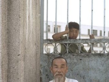 Two generations at the front gate of Jaedong Elementary School, 1969.  